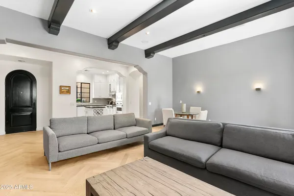 a living room with furniture white walls and a flat screen tv