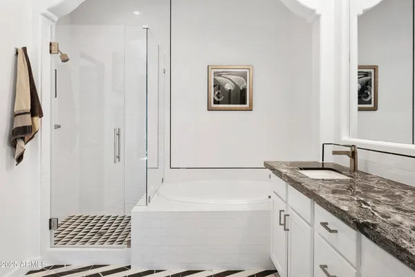 a bathroom with a granite countertop sink a toilet a shower a mirror and vanity