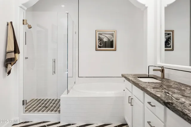 a bathroom with a granite countertop sink a toilet a shower a mirror and vanity