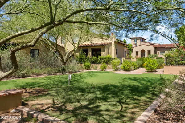 a house with green field in front of it