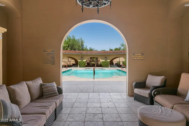 a living room with a couch and a floor to ceiling window