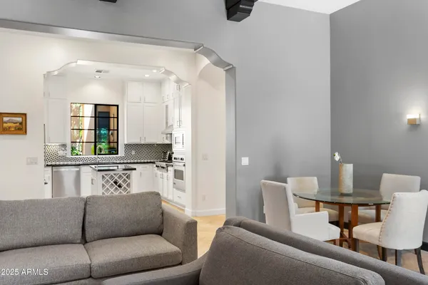 a living room with furniture and a mirror