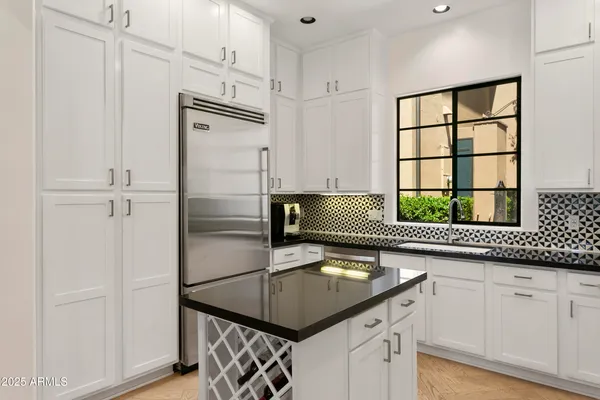 a kitchen with a refrigerator and a sink