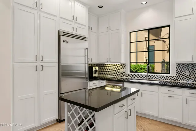 a kitchen with a refrigerator and a sink