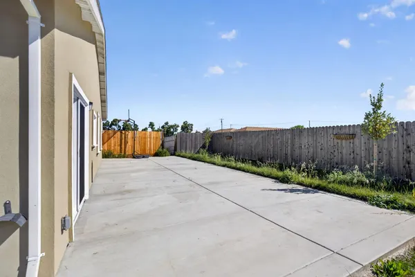 a view of a street with wooden fence
