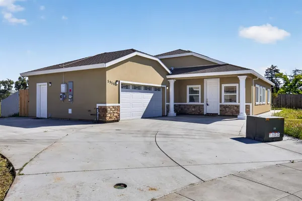 a front view of a house with garage