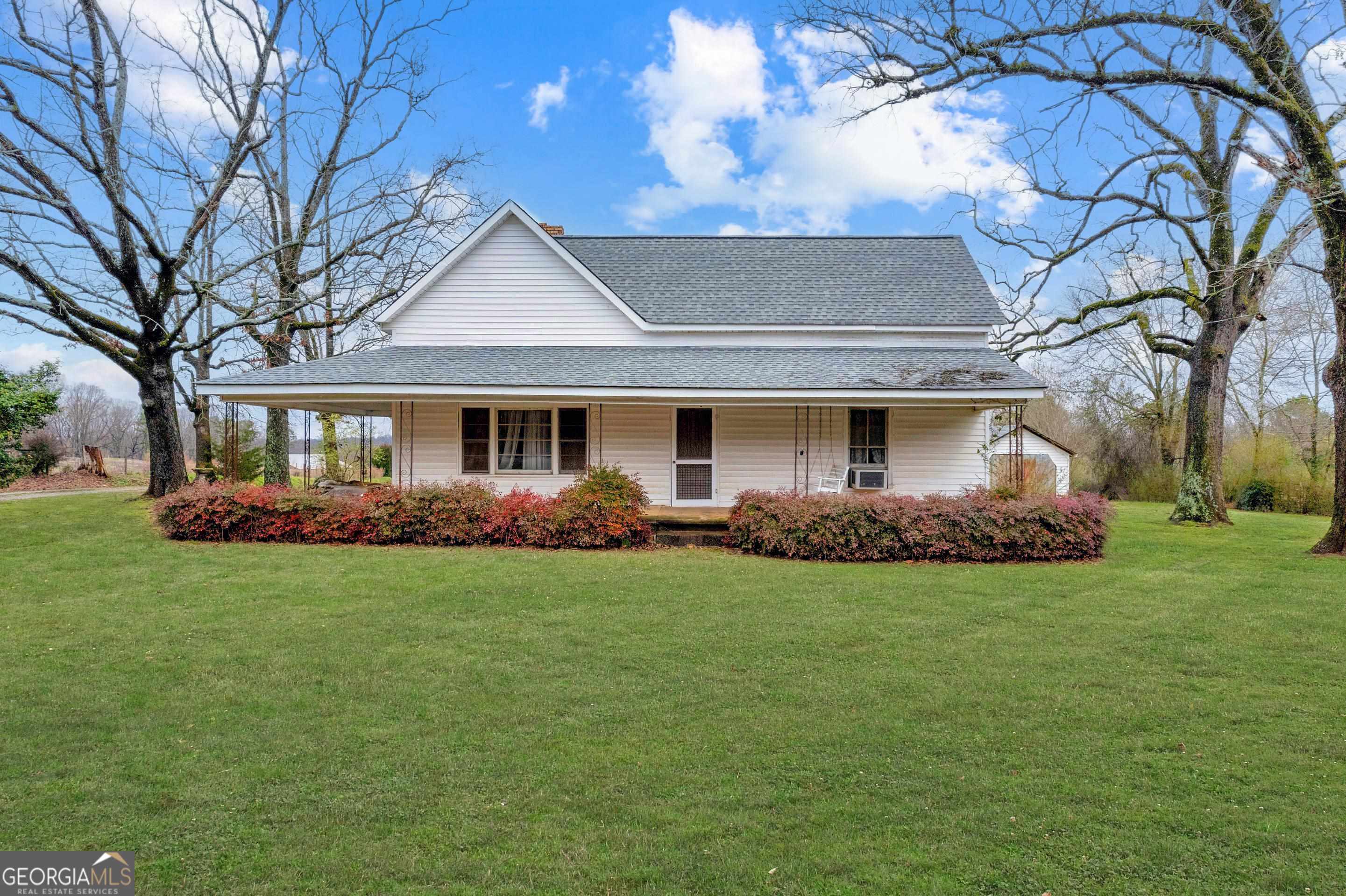 a front view of a house with a garden