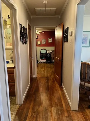 a view of a hallway view with wooden floor and staircase