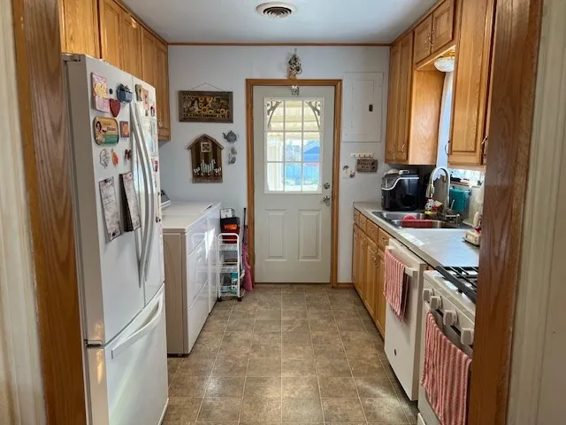 a kitchen with refrigerator a sink and dishwasher