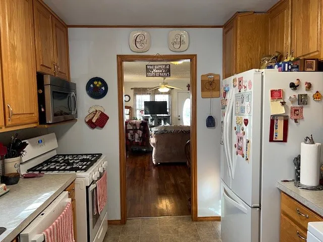 a kitchen with stainless steel appliances granite countertop a refrigerator and a stove