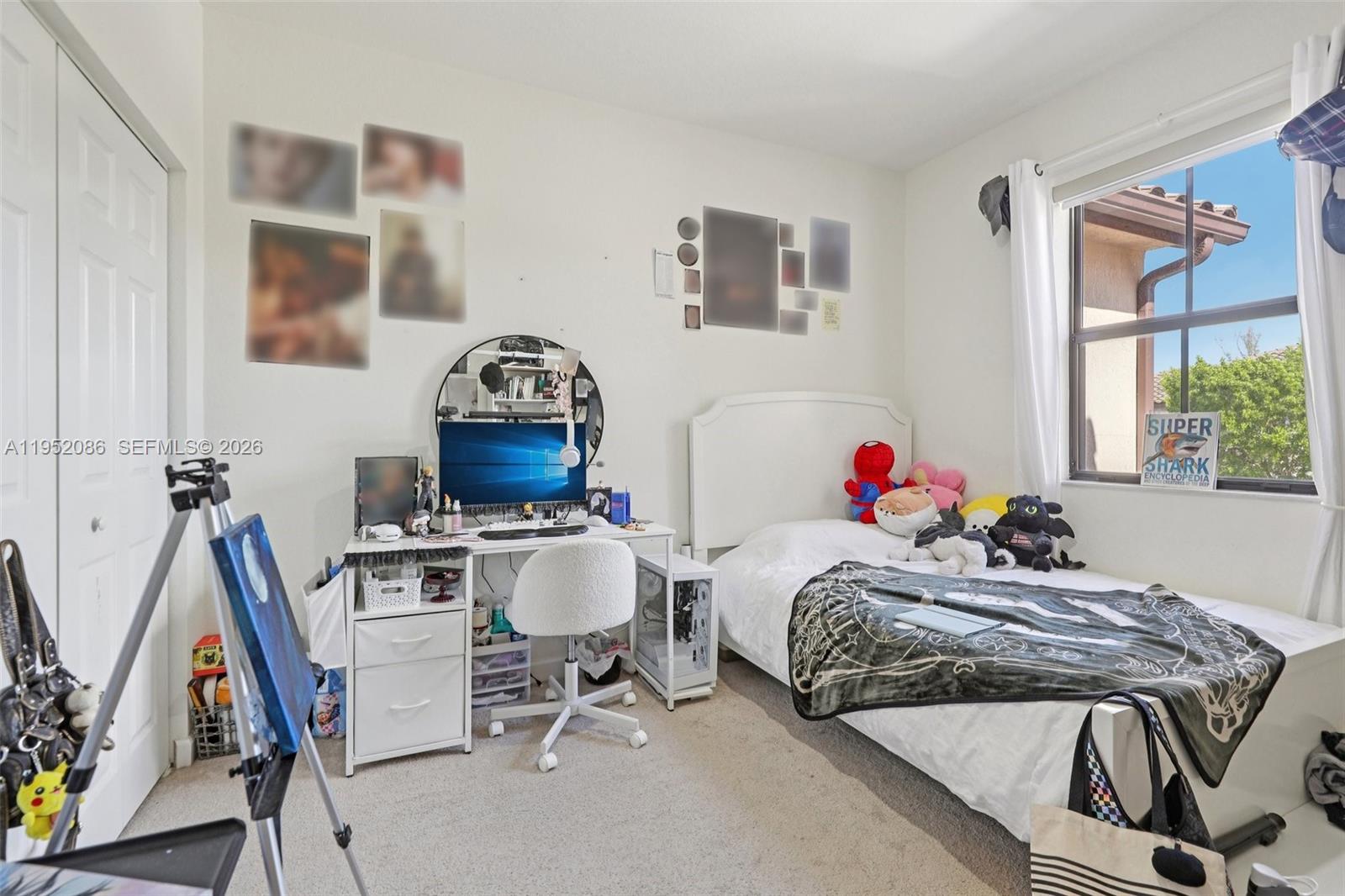 11746 Southwest 151 Avenue Miami, FL 33196 - Photo 17 of 37 a bedroom with a bed a rug and a window