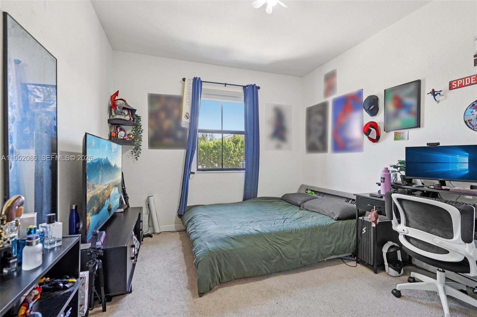 11746 Southwest 151 Avenue Miami, FL 33196 - Photo 20 of 37 a bedroom with a bed and a flat tv screen on the dresser