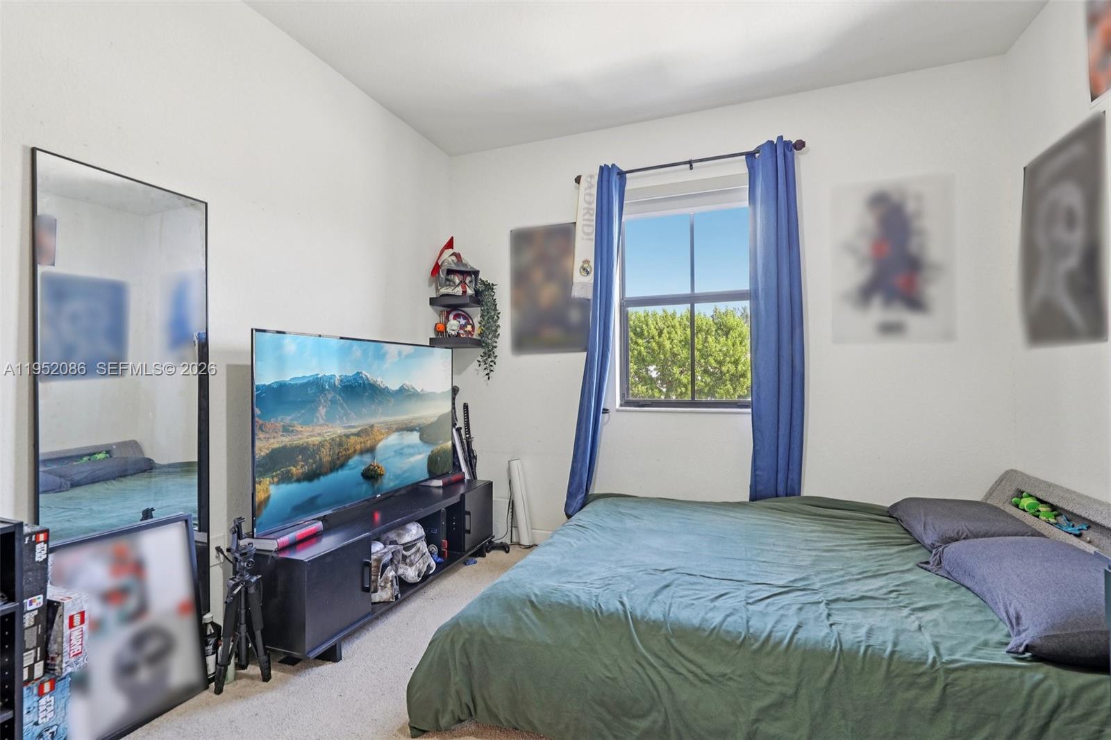 11746 Southwest 151 Avenue Miami, FL 33196 - Photo 22 of 37 a bedroom with a bed and a flat screen tv