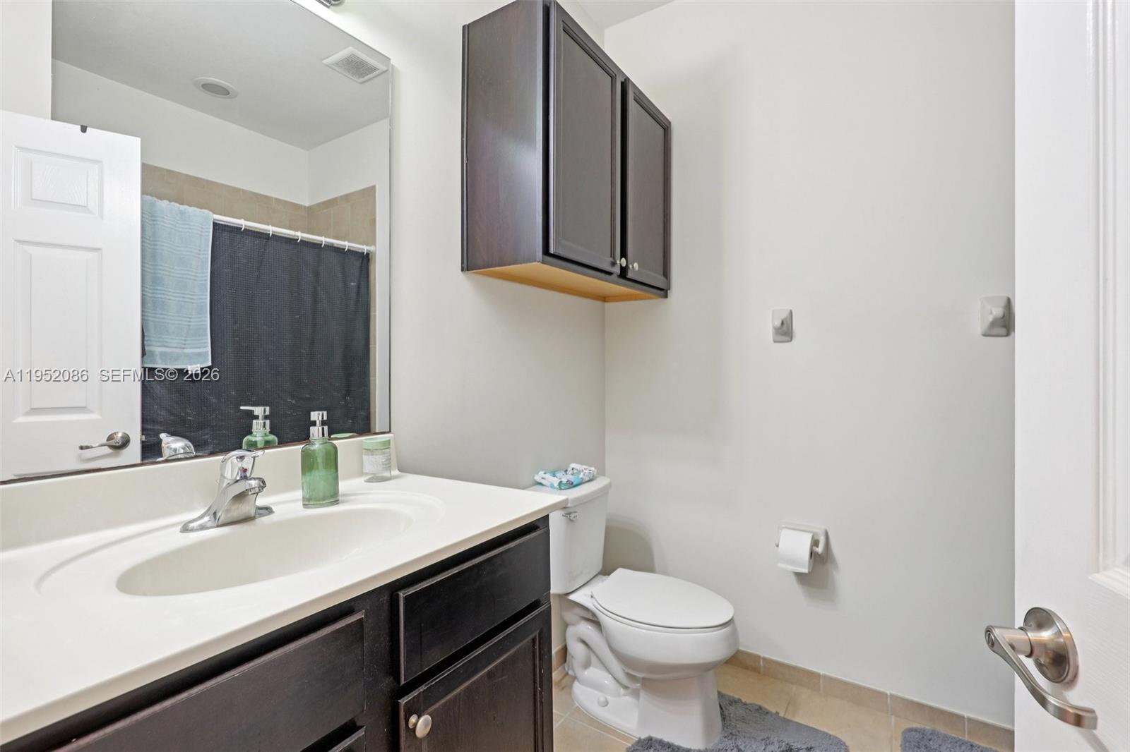 11746 Southwest 151 Avenue Miami, FL 33196 - Photo 23 of 37 a bathroom with a sink and a mirror
