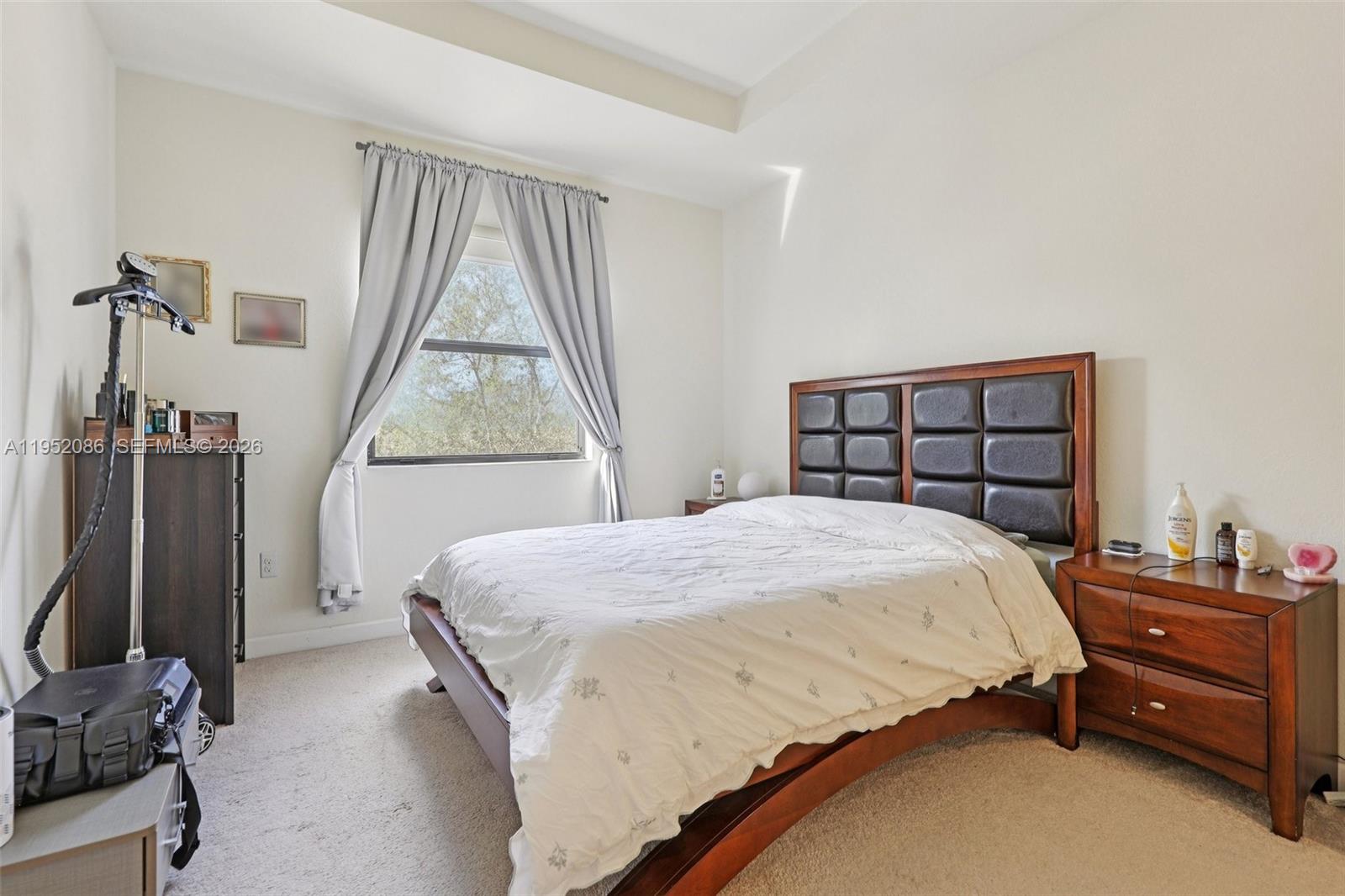 11746 Southwest 151 Avenue Miami, FL 33196 - Photo 28 of 37 a bedroom with a bed closet and a window