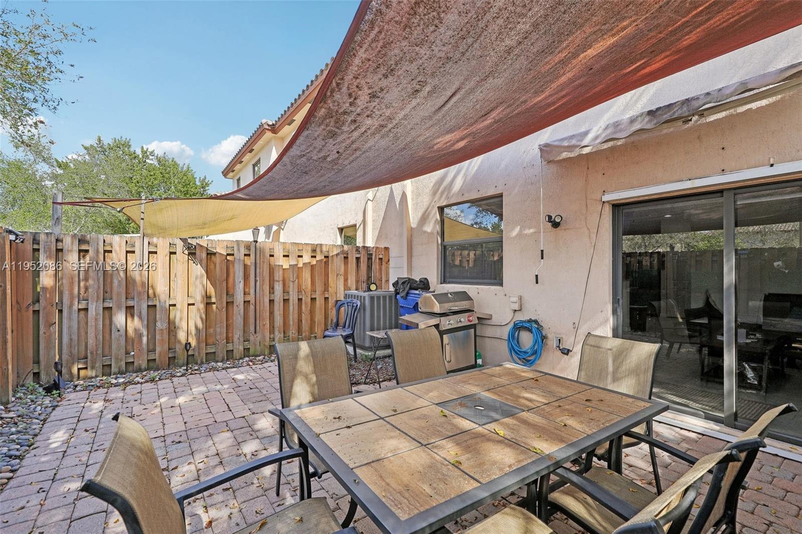 11746 Southwest 151 Avenue Miami, FL 33196 - Photo 37 of 37 a backyard of a house with barbeque oven table and chairs