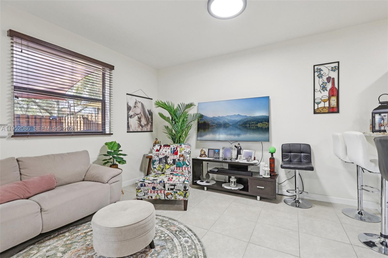 11746 Southwest 151 Avenue Miami, FL 33196 - Photo 5 of 37 a living room with furniture and a potted plant