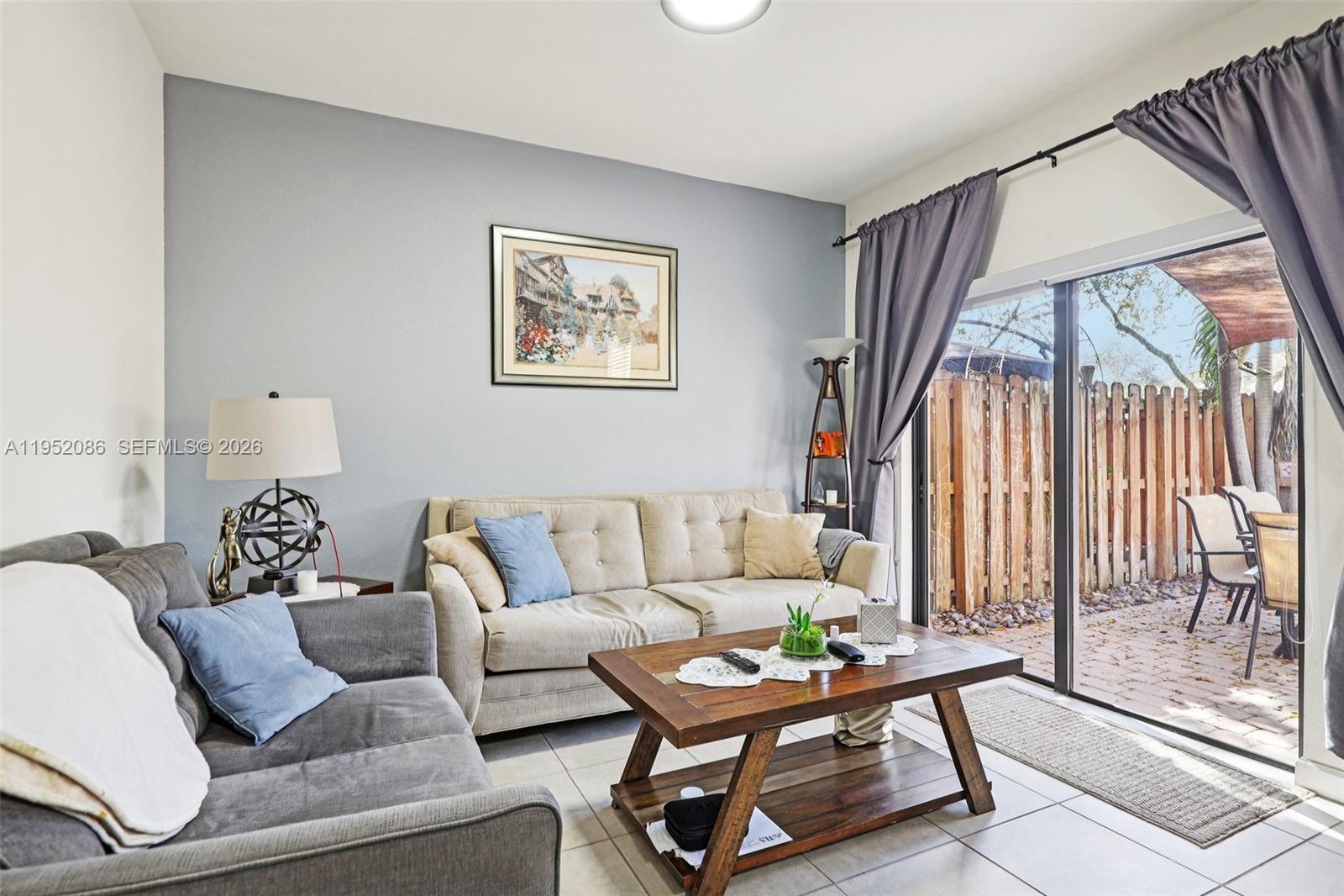 11746 Southwest 151 Avenue Miami, FL 33196 - Photo 7 of 37 a living room with furniture and a large window