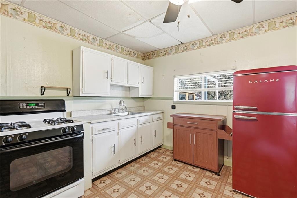1616 Myler Street Pittsburgh, PA 15212 - Photo 4 of 25 a kitchen with stainless steel appliances granite countertop a stove a sink and a refrigerator