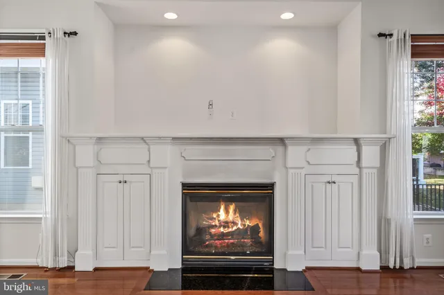 a large white kitchen with white cabinets and stainless steel appliances