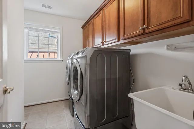 an empty room with wooden floor and fan