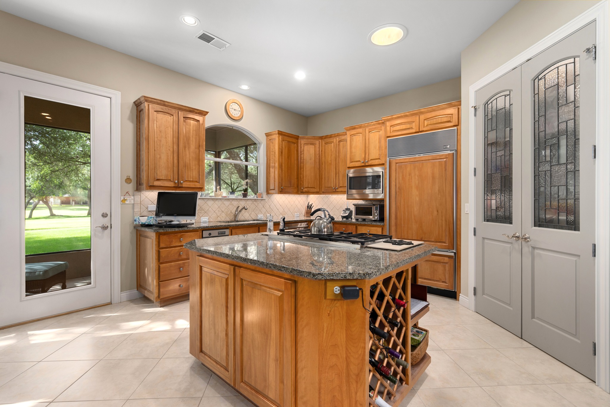 29 Meadows End Georgetown, TX 78628 - Photo 11 of 38 a kitchen with stainless steel appliances granite countertop a stove a refrigerator a sink a dining table and chairs