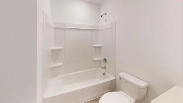 a bathroom with a toilet and a bathtub