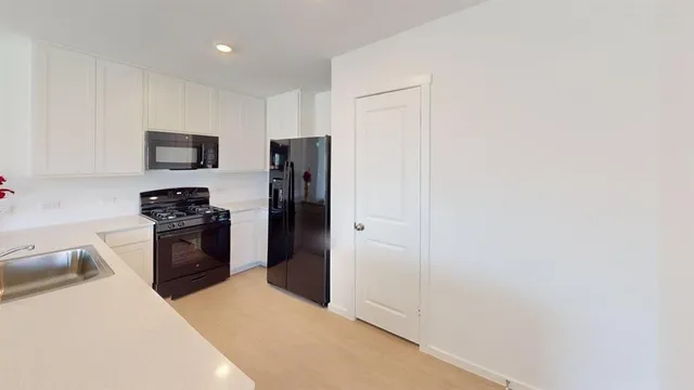 a kitchen with a refrigerator stove and a sink