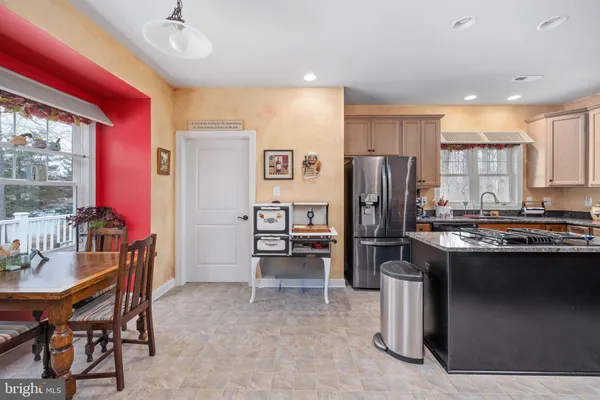 a kitchen with stainless steel appliances granite countertop a stove a sink dishwasher and refrigerator