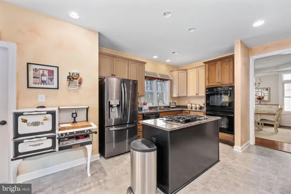 a view of a kitchen with fridge and wooden floor