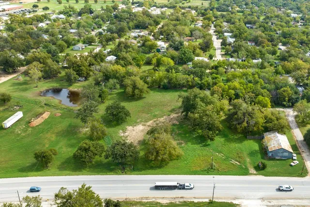 a view of a green field with an ocean