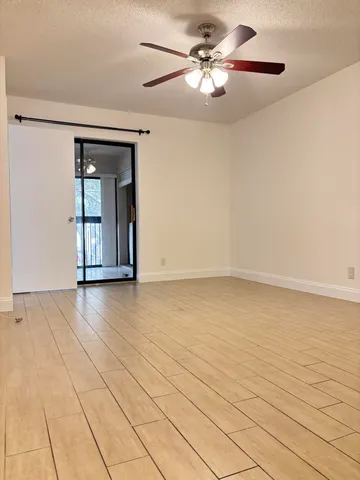 a view of an empty room with glass door