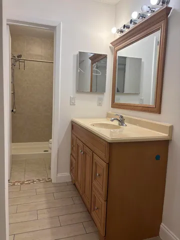 a bathroom with a sink a vanity and a mirror