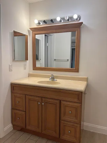 a bathroom with a sink and a mirror
