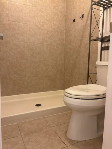 a bathroom with a toilet and a shower
