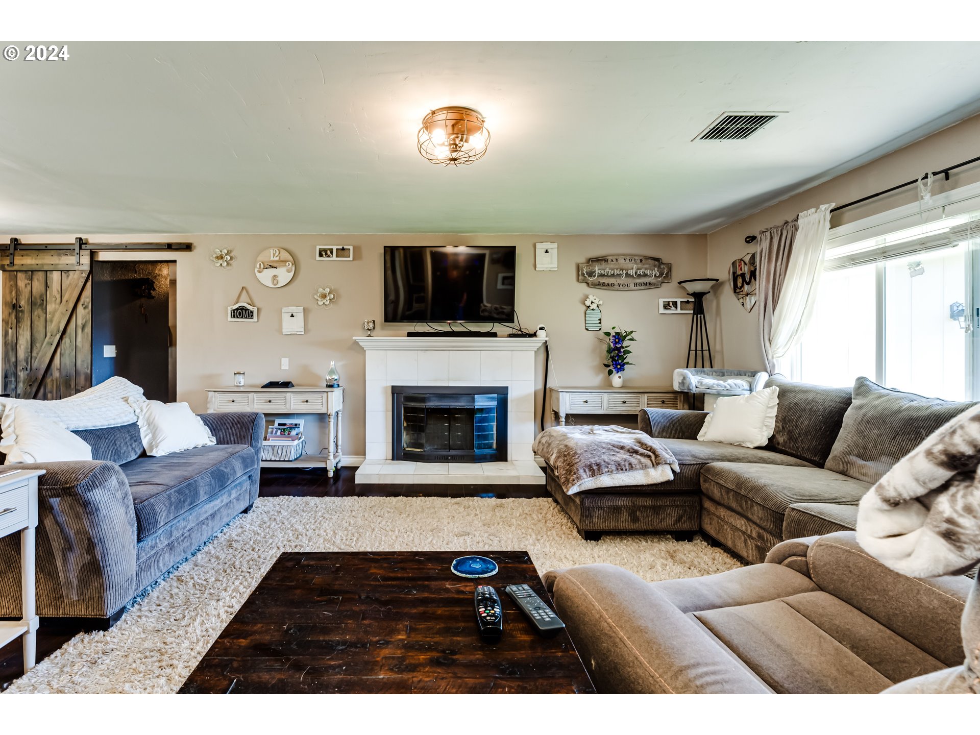 2288 9th Street Springfield, OR 97477 - Photo 6 of 41 a living room with furniture a flat screen tv and a fireplace