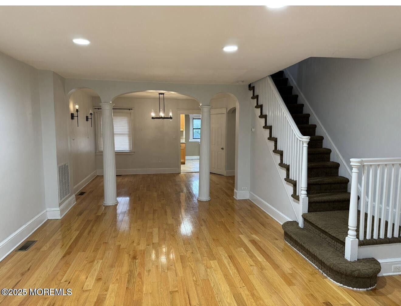 1001 Norwood Avenue, Unit 4 Long Branch, NJ 07740 - Photo 2 of 9 a view of a hallway with wooden floor and staircase
