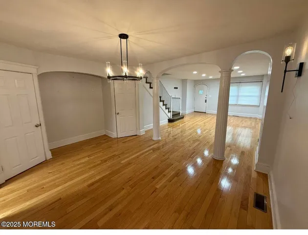 a kitchen with a refrigerator a stove top oven and cabinets
