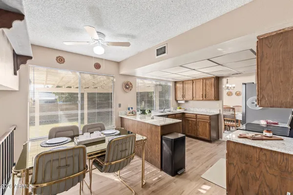 a kitchen with a stove a sink a dining table and chairs