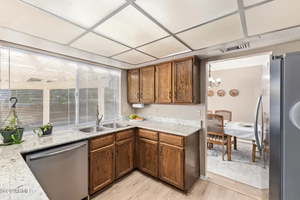 a kitchen with a sink and large windows