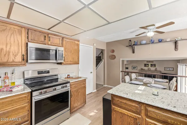 a kitchen with cabinets appliances and a counter space