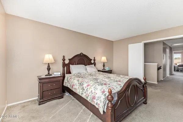 a bedroom with a bed and lamp