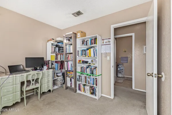 a room with furniture and a bookshelf