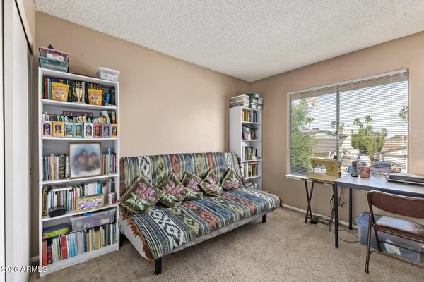 a bed room with a bed and a book shelf