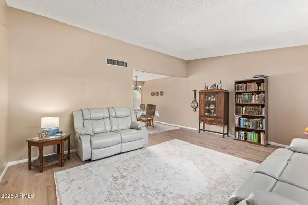 a living room with furniture and a book shelf