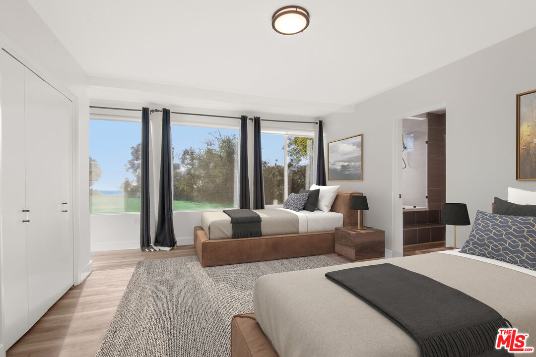 1001 Stradella Road Los Angeles, CA 90077 - Photo 16 of 28 a bedroom with furniture and a large window