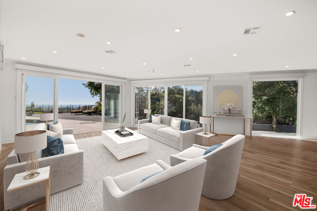1001 Stradella Road Los Angeles, CA 90077 - Photo 3 of 28 a living room with furniture and a large window