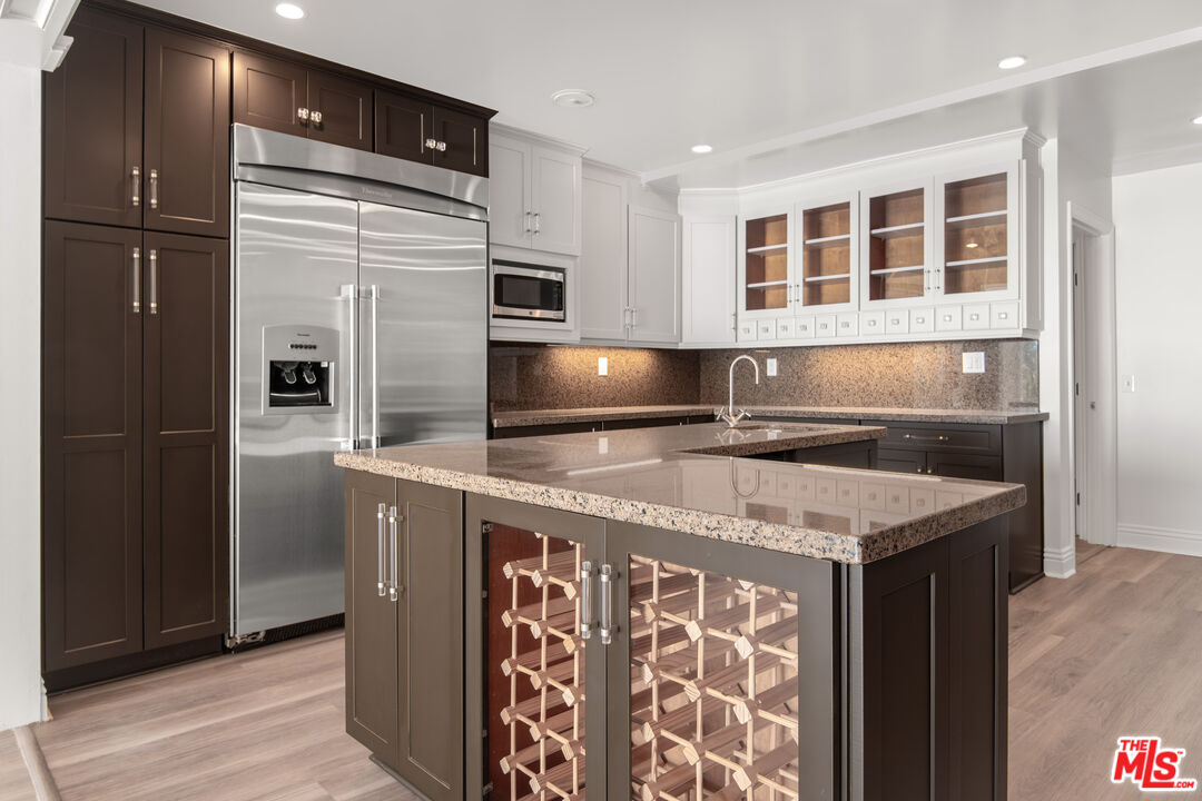 1001 Stradella Road Los Angeles, CA 90077 - Photo 6 of 28 a kitchen with stainless steel appliances granite countertop a refrigerator and a sink