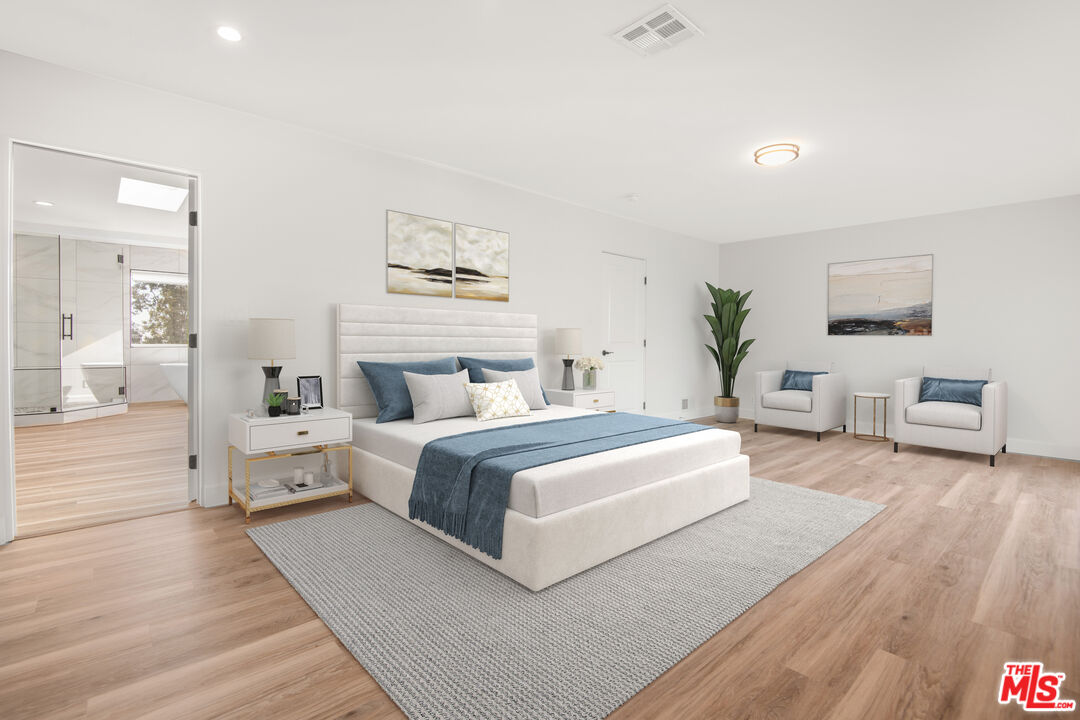 1001 Stradella Road Los Angeles, CA 90077 - Photo 9 of 28 a spacious bedroom with a large bed and wooden floor