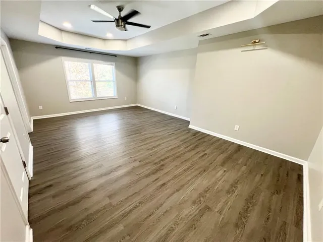 a view of a hallway with wooden floor and stairs